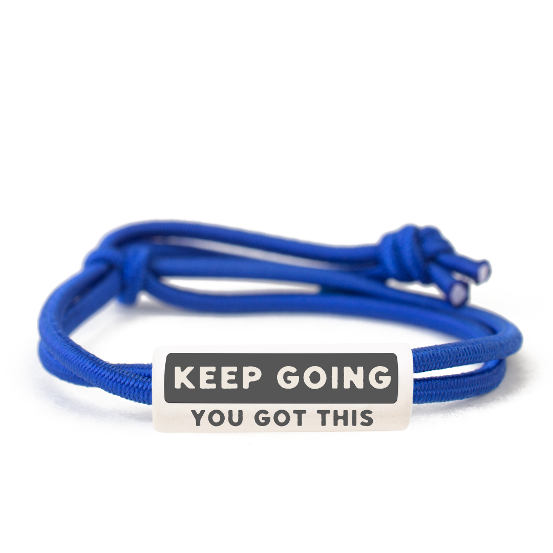 The Joni x MudLOVE Complete 10-Piece Set bracelet featuring a blue cord and a clay bead with the message &